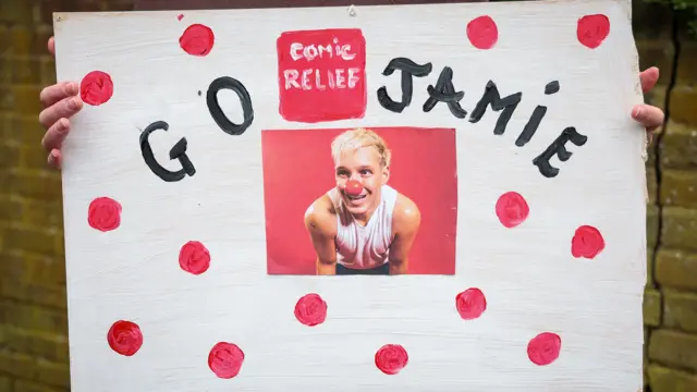 A homemade placard with the message 'Go Jamie' and a picture of Jamie surrounded by red polka dots