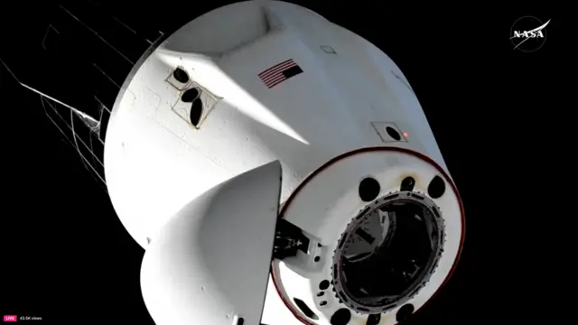 Photo of the capsule in space with the nose cone open