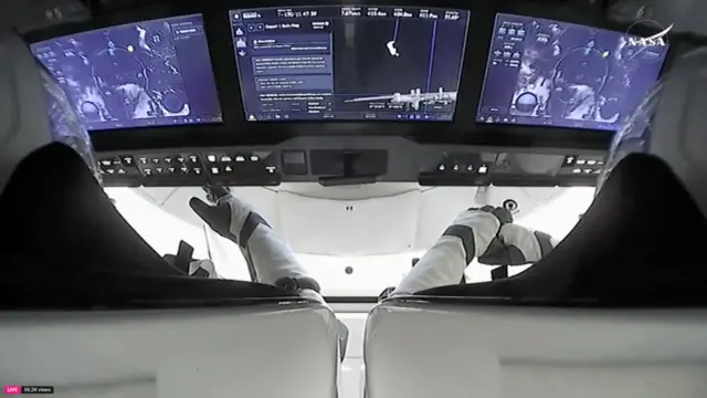 Astronauts are seen inside a SpaceX Crew Dragon capsule carrying Butch Wilmore and Suni Williams, two veteran NASA astronauts who have been stuck on the International Space Station for nine months,