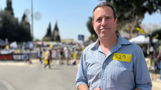 Samuel outside the protest - 529 is a reference to the number of days since the 7 October attacks, and the taking of the hostages