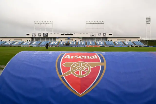 Arsenal dugout from behind with a view of Estadio Alfredo di Stefano