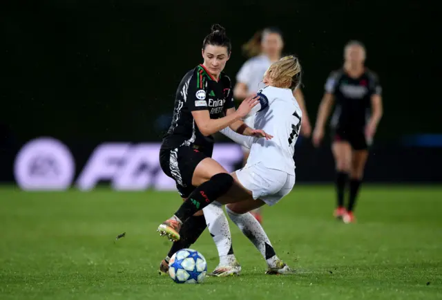 Emily Fox of Arsenal is challenged by Olga of Real Madrid