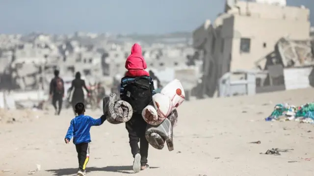 People walking on dusty street