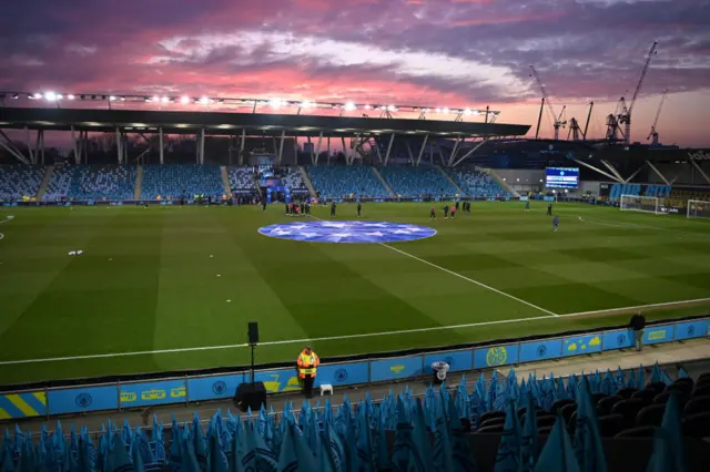 Players check out the conditions as the sun sets ahead of the UEFA Women's Champions League quarter-final first-leg football match between Manchester City and Chelsea at the Joie Stadium.