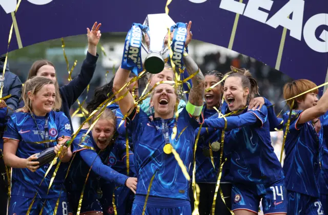 Millie Bright lifts the League Cup trophy