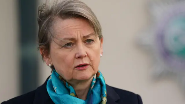 Head and shoulders image of Yvette Cooper, wearing a silky, blue scarf around her neck