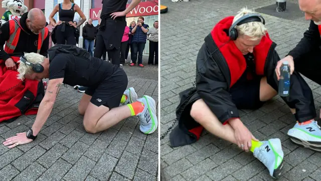 Jamie on his knees and sitting on the floor with his trainer handing him a bottle of water