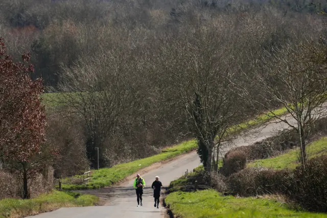Jamie Laing and his trainer start a huge ascent up a steep hill