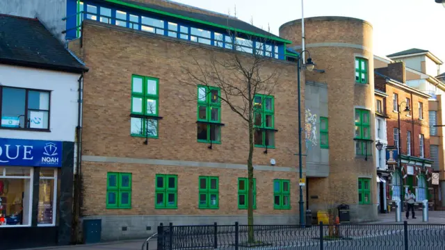 Luton Crown Court - a modern brick building with a circular vertical section and green window frames