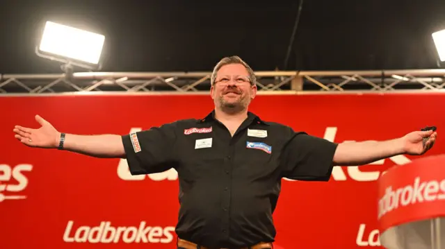 James Wade celebrates