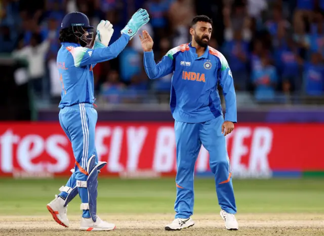 Varun Chakravarthy of India celebrates with team-mate KL Rahul