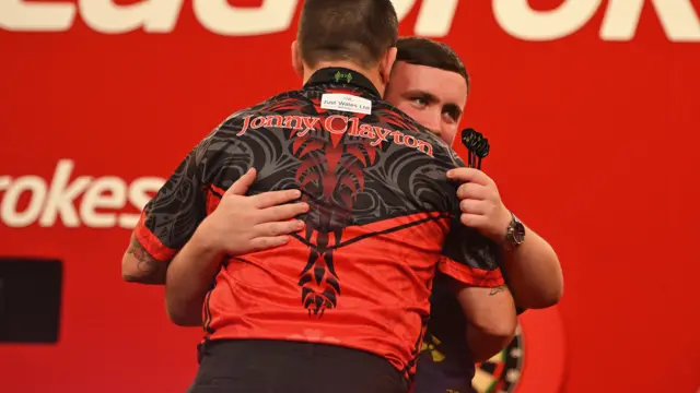 Luke Littler embraces Jonny Clayton