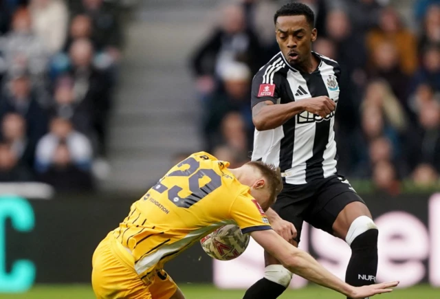 Newcastle United's Joe Willock (right) is tackled by Brighton and Hove Albion's Jan Paul van Hecke