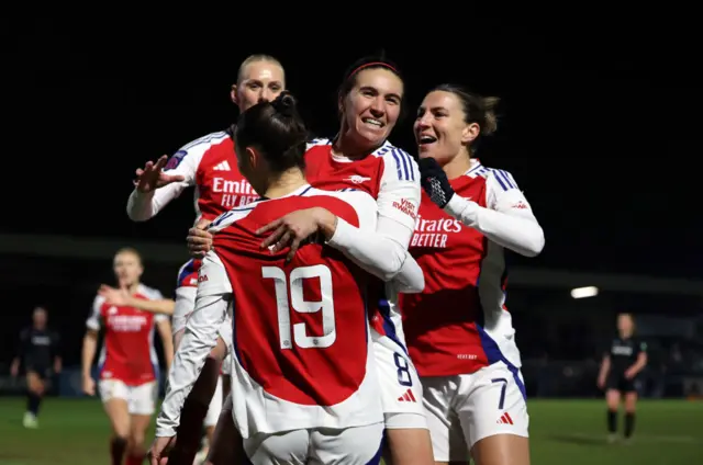 Arsenal's players congratulate Foord for her assist for McCabe's goal