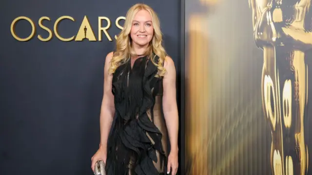 Lynette Howell wearing a black frilled sheer dress on the Oscars red carpet