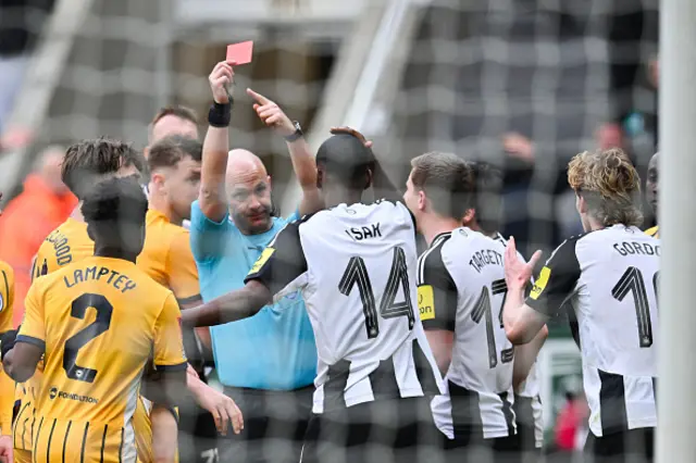 Anthony Taylor shows a red card