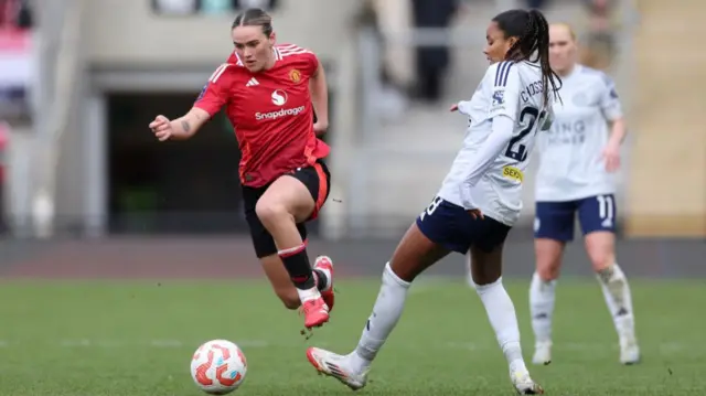 Man United's Grace Clinton competes for the ball