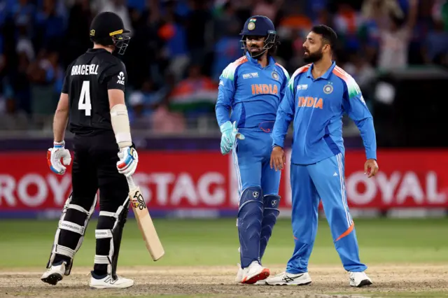 Varun Chakravarthy of India celebrates with teammates KL Rahul after taking the wicket of Michael Bracewell of New Zealand