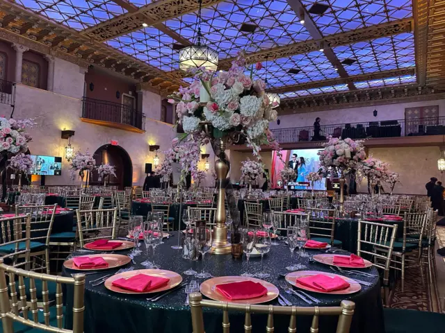 A circular table with a huge floral decoration in the middle