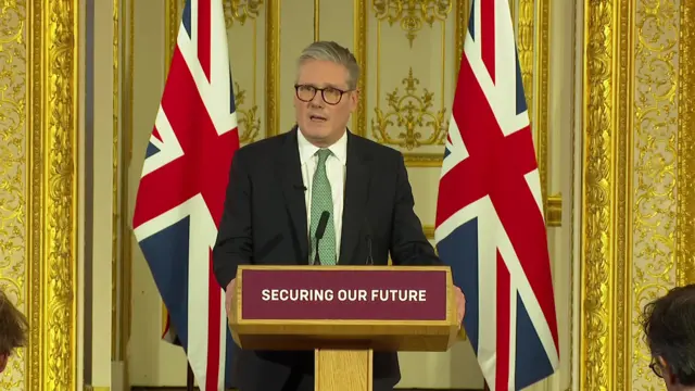 Keir Starmer standing behind podium