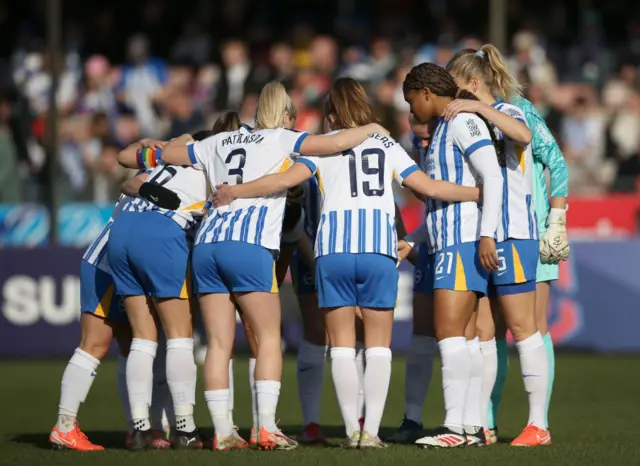 Brighton players huddle before kick off against Chelsea