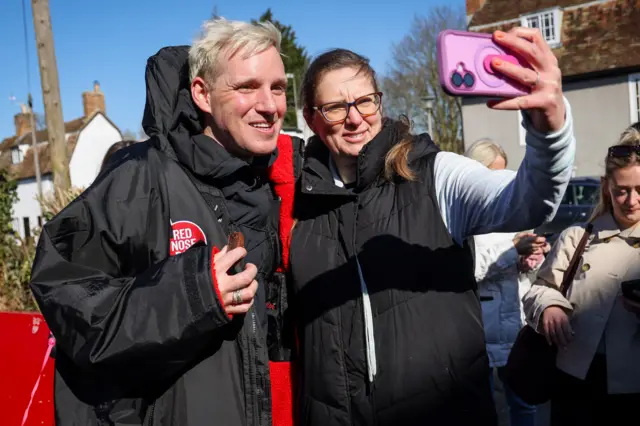 Jamie Laing poses for a photo with a fan