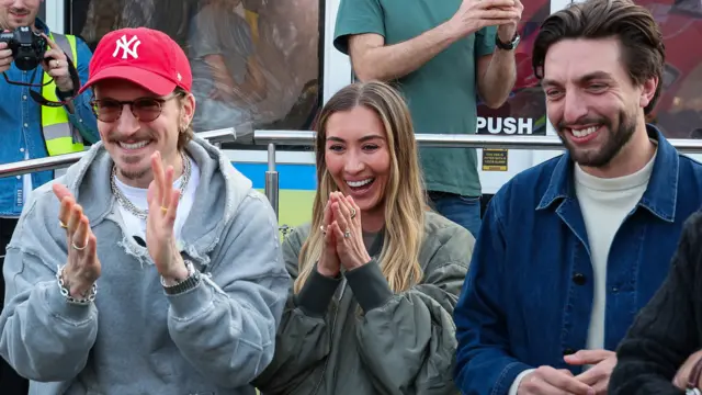 Jamie's best mate Ollie Proudlock, wife Sophie Habboo, and business partner Edward Sweet-Williams cheer him on