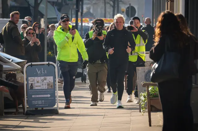 Jamie Laing runs past crowds in Market Harborough