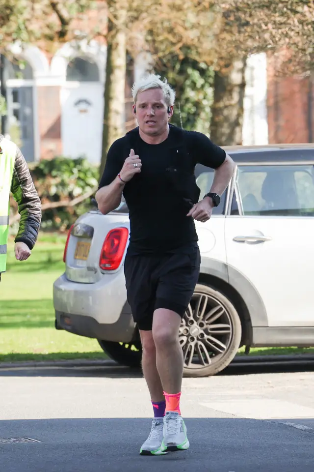 Jamie running with an anguished look on his face.