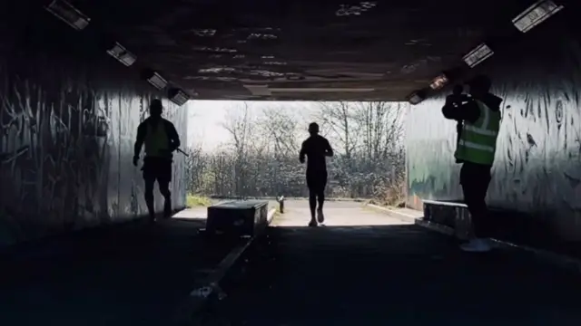 Jamie Laing running under a tunnel