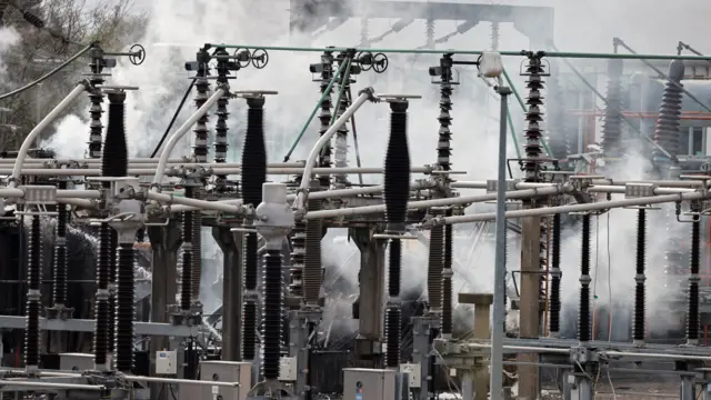 Smoke rises as firefighters work at the area of an electrical substation, after a fire there wiped out the power at Heathrow International Airport