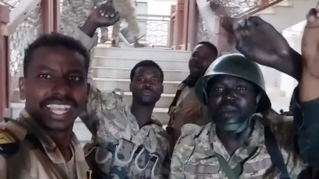 Sudanese army members celebrate inside the presidential palace, after, according to the Sudanese army, they took the control of the presidential palace, in Khartoum, Sudan,