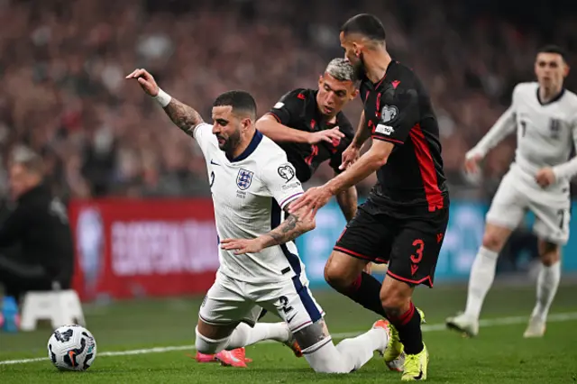 Kyle Walker of England is challenged by Myrto Uzuni and Naser Aliji