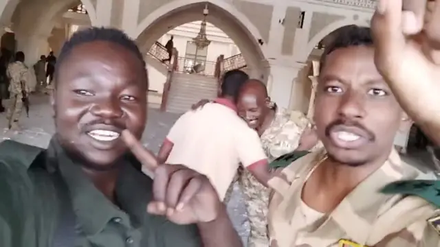 Sudanese army members celebrate inside the presidential palace, after, according to the Sudanese army, they took the control of the presidential palace, in Khartoum, Sudan,