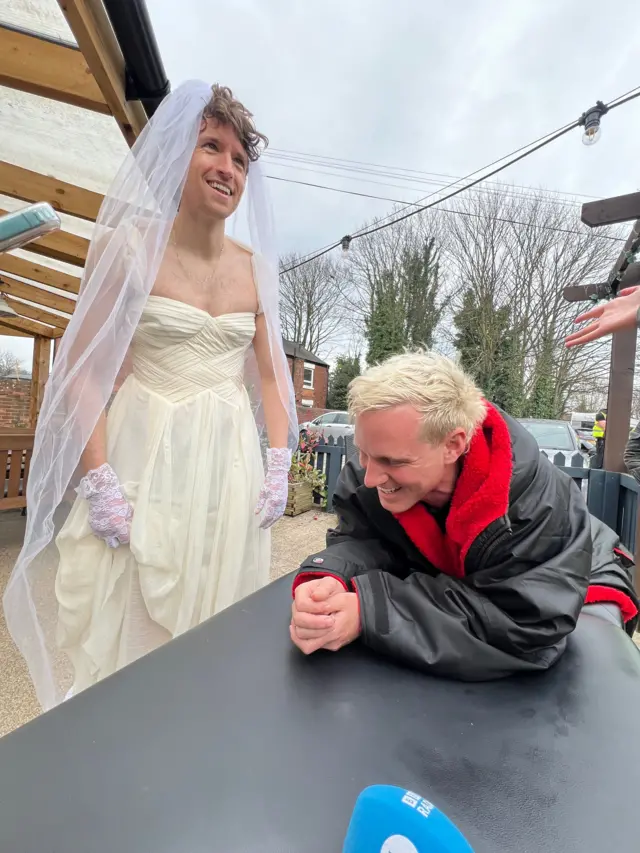 Greg James in wedding dress, alongside Jamie Laing