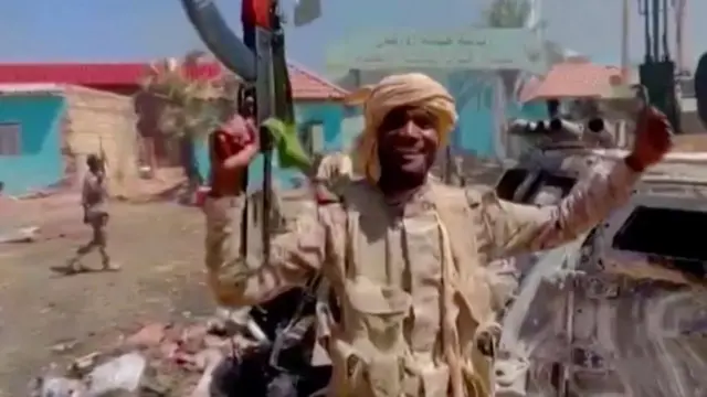 A member of the RSF forces walks around the destroyed Air Defence Forces command site in Khartoum, Sudan, in this screengrab obtained from a social media video on June 14, 2023.