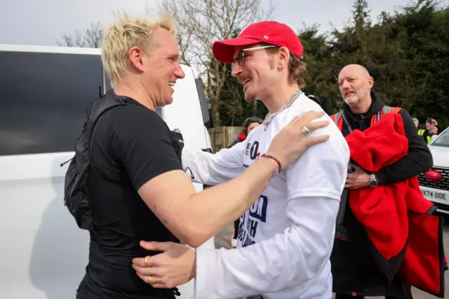 Jamie and Proudlock smiling and hugging