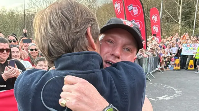 Jamie hugs his dad on the finish line