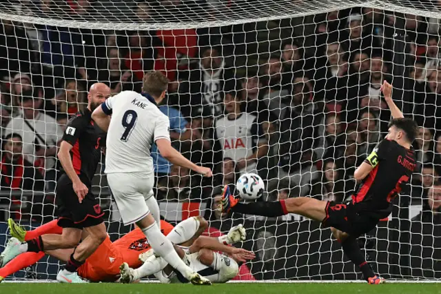 Berat Djimsiti (R) blocks a shot from England's striker Harry Kane