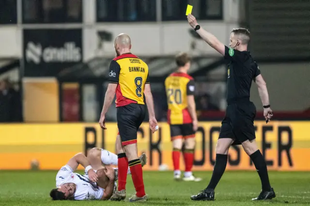 GLASGOW, SCOTLAND - MARCH 22: Partick's Stuart Bannigan is shown a yellow card by Referee Calum Scott during a William Hill Championship match between Partick Thistle and Raith Rovers at the Wyre Stadium at Firhill, on March 22, 2025, in Glasgow, Scotland. (Photo by Paul Byars / SNS Group)