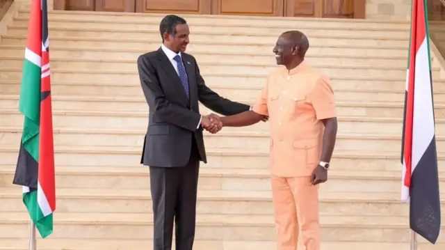 Gen Mohamed Hamdan Dagalo, better known as "Hemedti", shakes hands with Kenya's President William Ruto