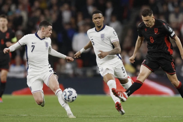 England's Phil Foden and Ezri Konsa in action with Albania's Kristjan Asllani