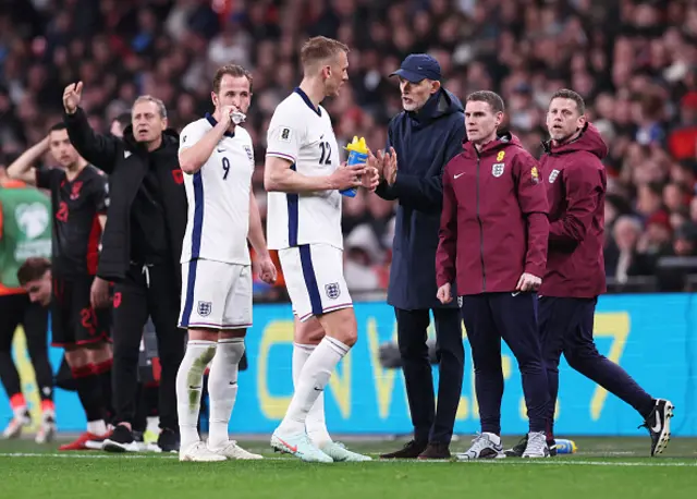 Thomas Tuchel, Head Coach of England speaks with Dan Burn