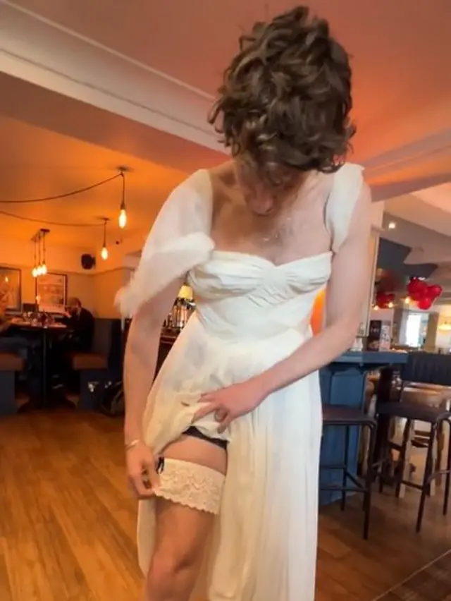 Greg James models the garter in anticipation of the moment where Jamie tore it off with his teeth