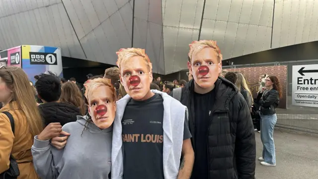 Crowds wear Jamie Laing masks