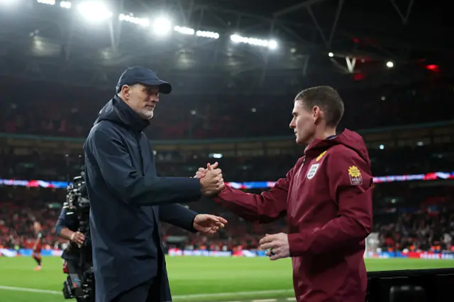 Thomas Tuchel, Head Coach of England, shakes hands with Anthony Barry