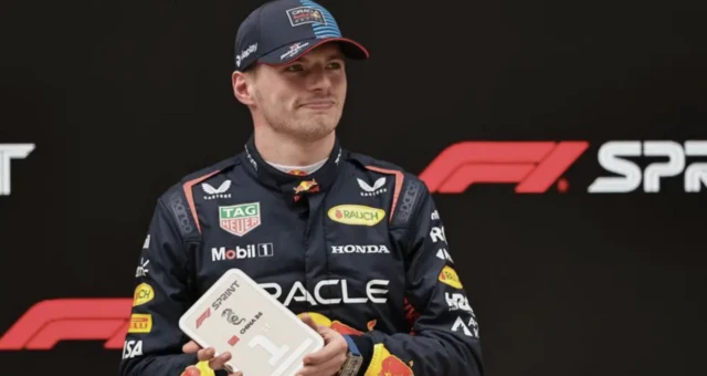 Max Verstappen holds up a sprint race winner's medal in Shanghai