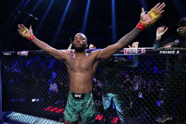 Leon Edwards holds out his arms as he stands in the octagon before facing Belal Muhammad