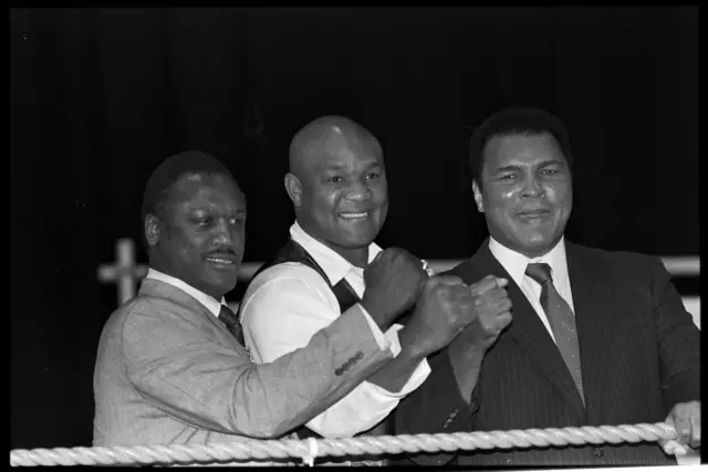 Joe Frazier, George Foreman and Muhammed Ali posing with their fists raised