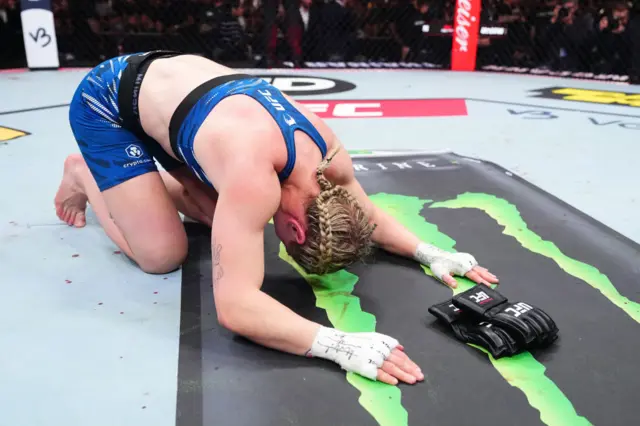 Molly McCann lies on the floor next to her UFC gloves after announcing her retirement